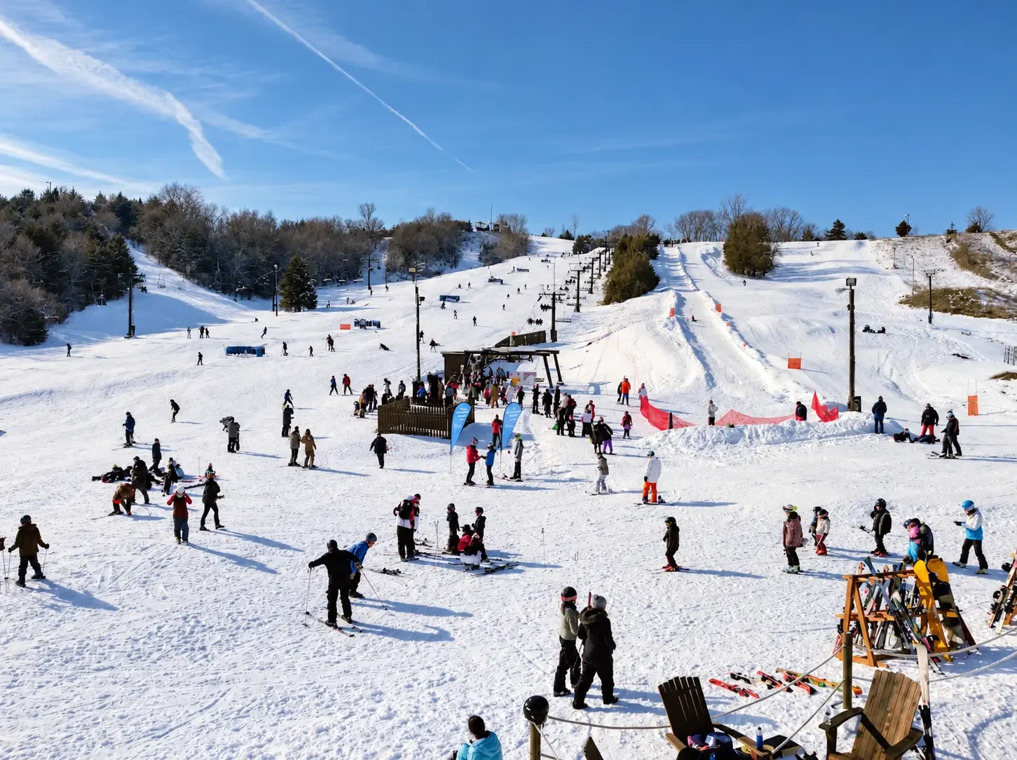 Skiers and snowboarders on a sunny day at Crescent Hill at Hitchcock