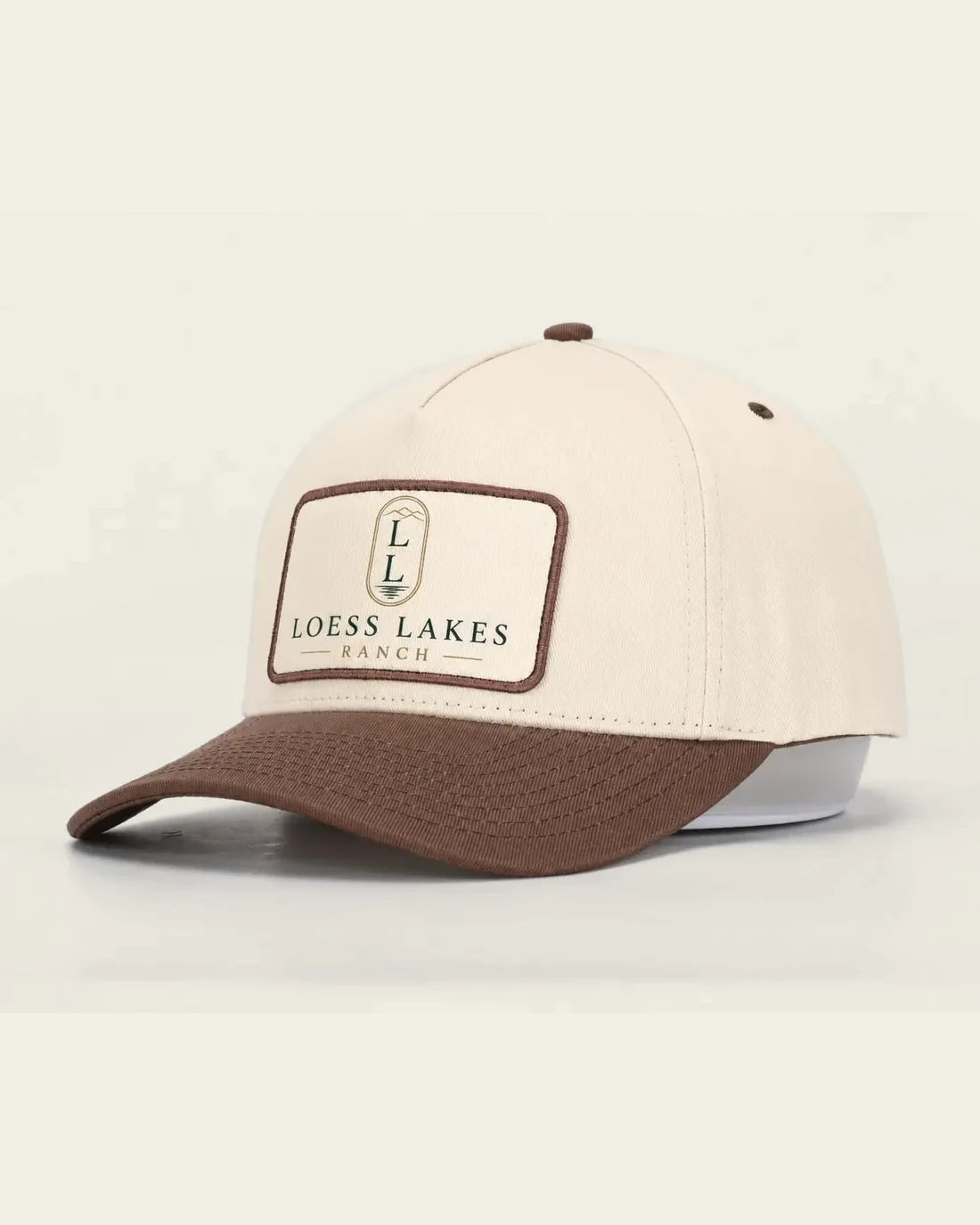 Cream cap with tobacco-brown bill and a rectangular LOESS LAKES RANCH patch