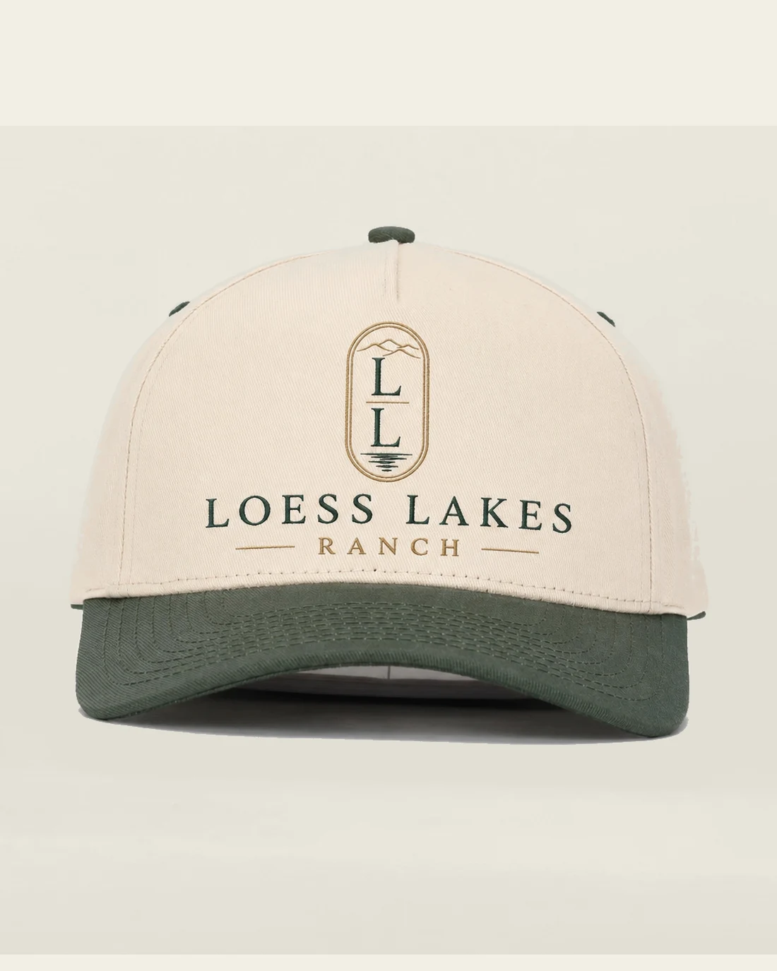 Cream cap with a forest-green bill and the stacked gold LL crest above the LOESS LAKES RANCH wordmark